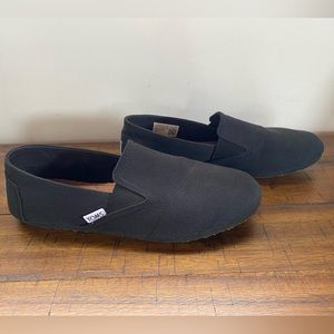 Tom’s black canvas slip-ons, size 8.